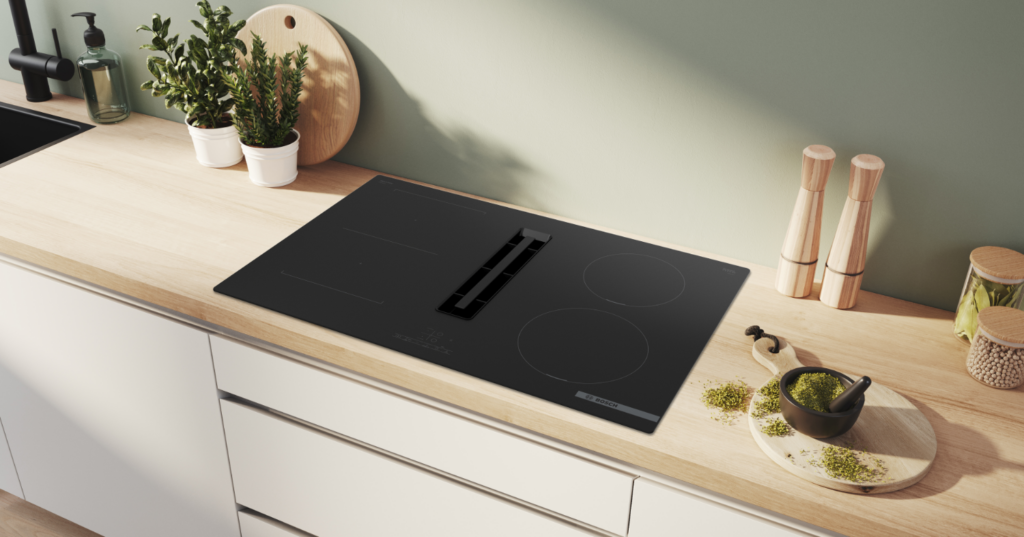 Placa de inducción con extractor integrado Bosch en una encimera de madera.
