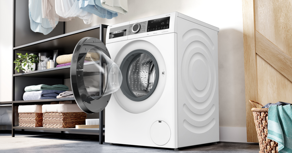 Lavadora Serie 6 Bosch en color blanco abierta colocada en un cuarto de lavado